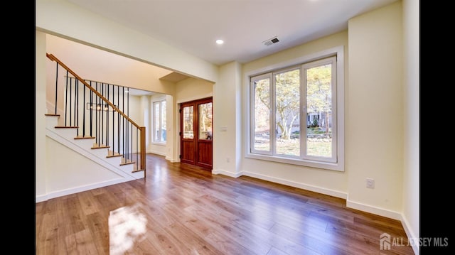 foyer featuring plenty of natural light and hardwood / wood-style floors