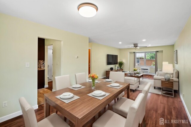 dining room with ceiling fan and dark hardwood / wood-style floors