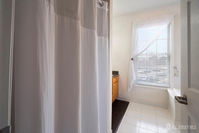 full bathroom featuring tile patterned floors, vanity, a shower with shower curtain, and baseboards