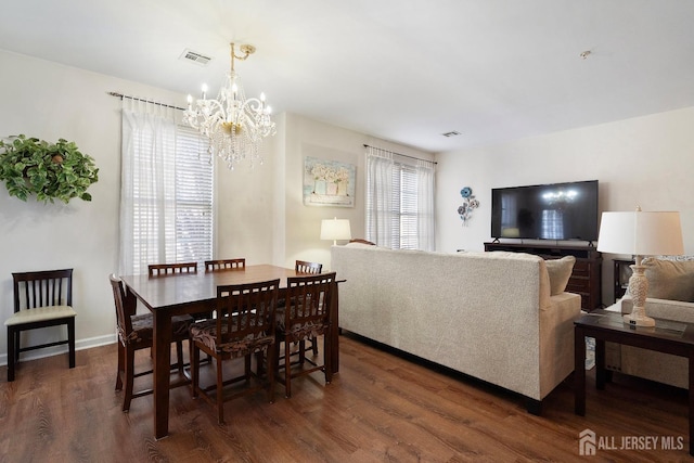 dining room with visible vents, baseboards, an inviting chandelier, and wood finished floors