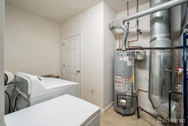 clothes washing area featuring light tile patterned floors, baseboards, laundry area, water heater, and washer and clothes dryer