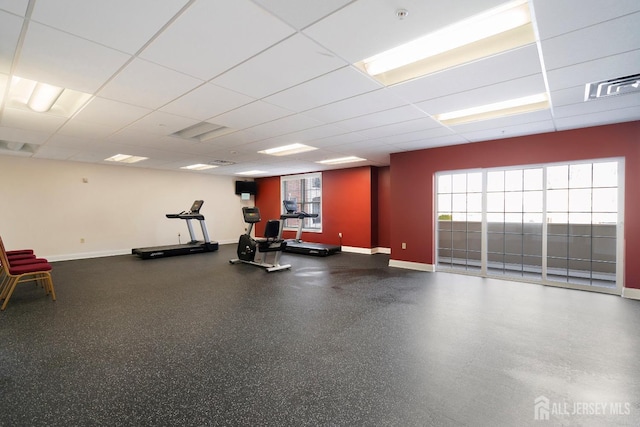 gym featuring a drop ceiling, baseboards, and visible vents