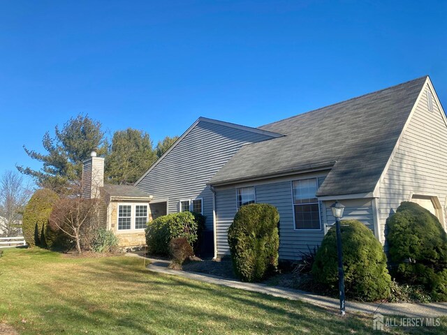 back of property featuring a yard