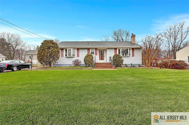 ranch-style home with a chimney and a front yard