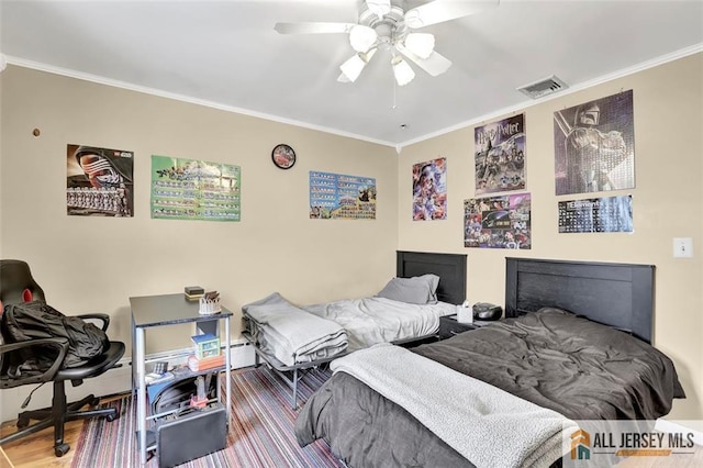 bedroom featuring a ceiling fan, visible vents, crown molding, and wood finished floors