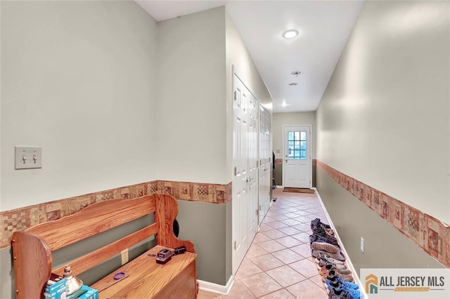 hall featuring light tile patterned floors