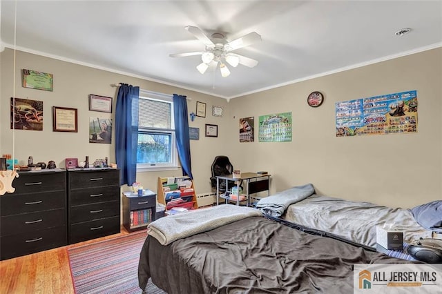 bedroom featuring visible vents, a ceiling fan, a baseboard radiator, ornamental molding, and wood finished floors