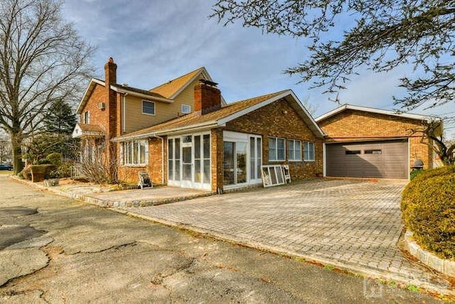 rear view of property featuring a garage