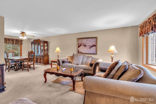 carpeted living room featuring ceiling fan