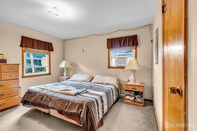 carpeted bedroom with cooling unit and multiple windows