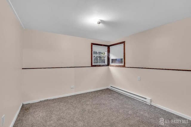 unfurnished room featuring carpet and a baseboard heating unit