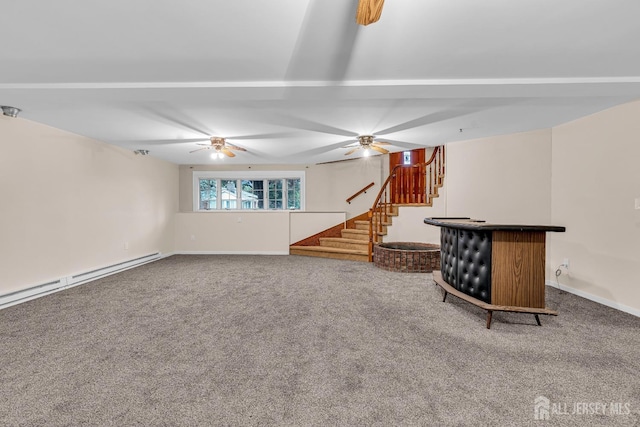 unfurnished living room featuring carpet flooring and a baseboard heating unit