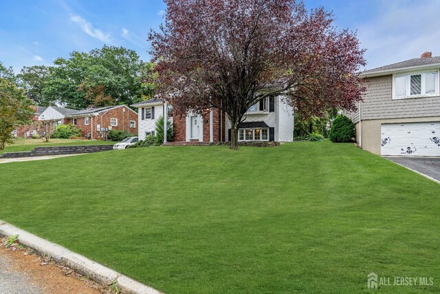 view of front facade with a front lawn and a garage