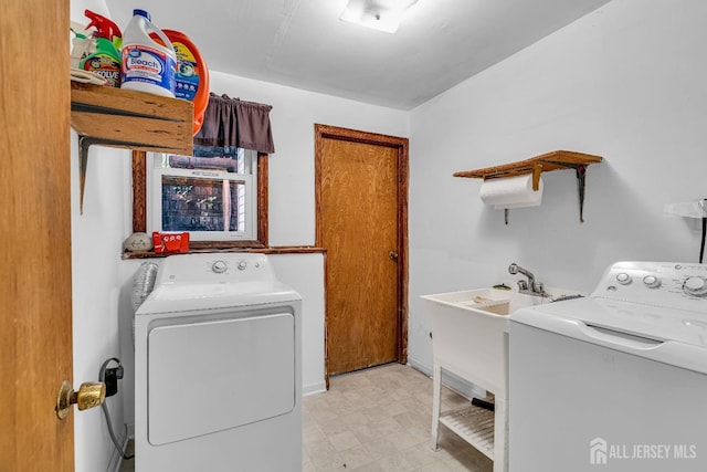 clothes washing area with washer and clothes dryer