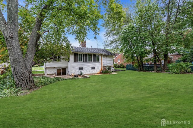 rear view of house with a yard