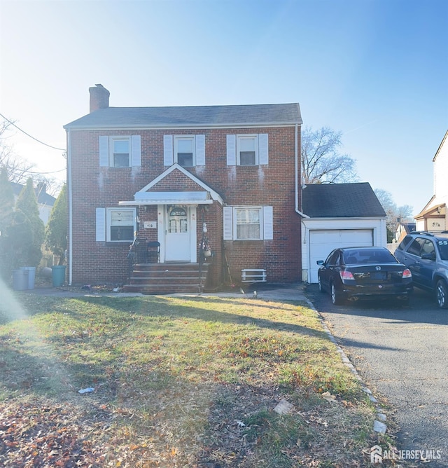 910 Roanoke Ave, Hillside, NJ 07205 - view of front of property featuring brick siding, a chimney, an attached garage, driveway, and a front yard