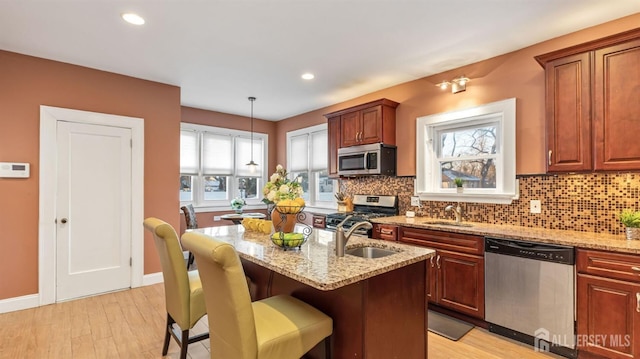 kitchen with backsplash, stainless steel appliances, and a sink