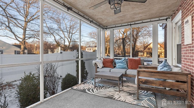 sunroom / solarium with a ceiling fan