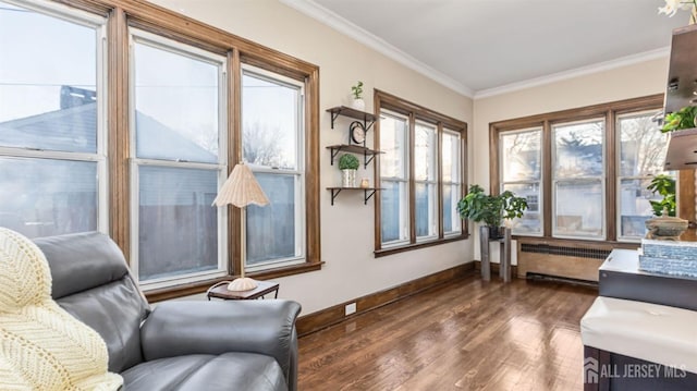 living room featuring baseboards, dark wood-style flooring, radiator heating unit, and crown molding