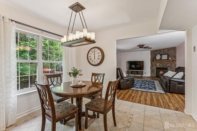 192 Middlesex Ave, Piscataway, NJ 08854 - dining area featuring light tile patterned floors, a fireplace, ceiling fan, and healthy amount of natural light