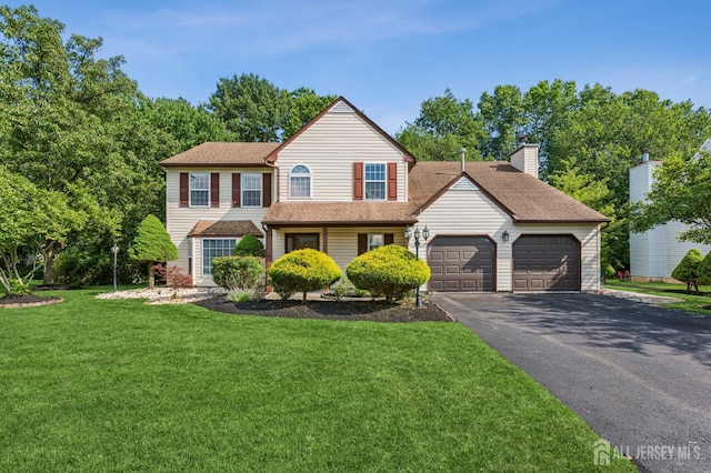 192 Middlesex Ave, Piscataway, NJ 08854 - view of front of home with an attached garage, driveway, a front lawn, and a chimney