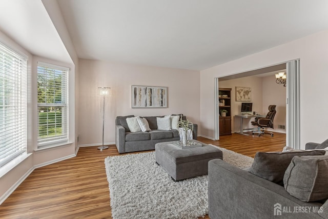192 Middlesex Ave, Piscataway, NJ 08854 - living room with light wood-type flooring, a desk, and a chandelier