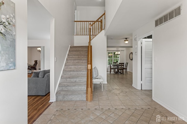 192 Middlesex Ave, Piscataway, NJ 08854 - stairway featuring tile patterned floors and a chandelier
