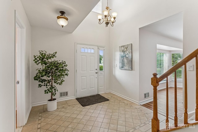 192 Middlesex Ave, Piscataway, NJ 08854 - entrance foyer with a chandelier, light tile patterned floors, and stairs