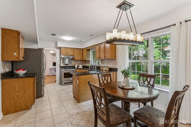 192 Middlesex Ave, Piscataway, NJ 08854 - kitchen featuring stainless steel appliances, brown cabinets, light tile patterned floors, and decorative backsplash
