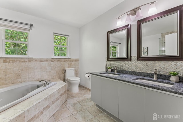 192 Middlesex Ave, Piscataway, NJ 08854 - full bathroom featuring double vanity, a garden tub, tile patterned floors, and backsplash