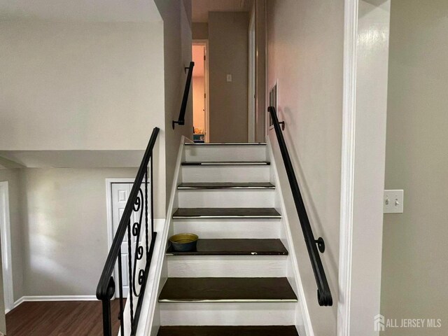 stairway with hardwood / wood-style flooring