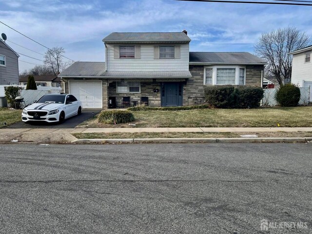 view of front of house with a front lawn and a garage