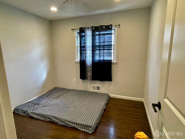 bedroom with dark wood-type flooring and ceiling fan