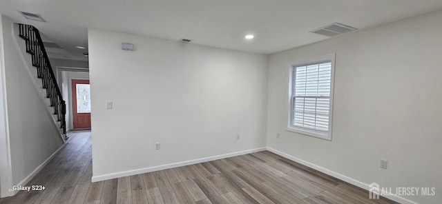 unfurnished room with hardwood / wood-style floors