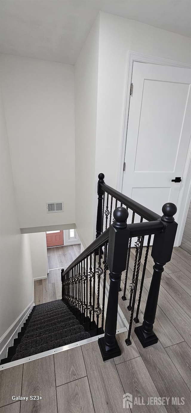 stairs featuring wood-type flooring