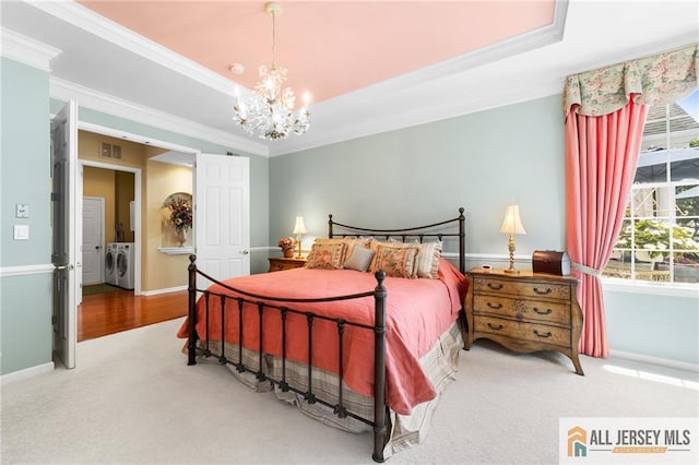 8 Tamarack Rd, Monroe, NJ 08831 - carpeted bedroom featuring washing machine and dryer, ornamental molding, a chandelier, and a raised ceiling