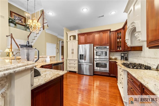 8 Tamarack Rd, Monroe, NJ 08831 - kitchen featuring appliances with stainless steel finishes, crown molding, decorative backsplash, pendant lighting, and wood finished floors