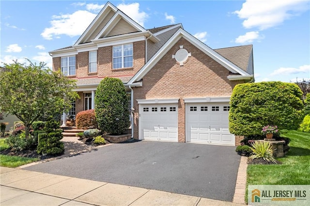 8 Tamarack Rd, Monroe, NJ 08831 - view of front facade featuring asphalt driveway, a garage, and brick siding