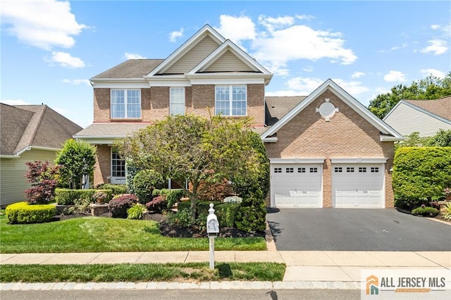 8 Tamarack Rd, Monroe, NJ 08831 - view of front of property with driveway, brick siding, and an attached garage