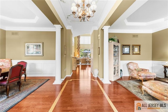8 Tamarack Rd, Monroe, NJ 08831 - hallway with decorative columns, a raised ceiling, ornamental molding, wood finished floors, and a decorative wall
