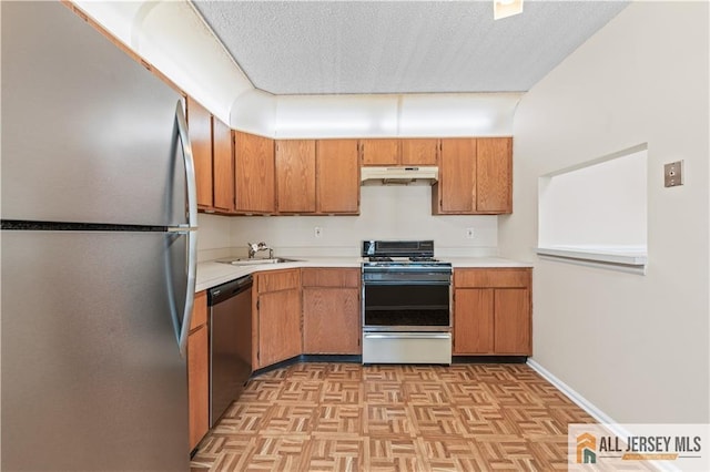 81 Fisher Dr Unit 2503, Franklin, NJ 08823 - kitchen with appliances with stainless steel finishes, under cabinet range hood, light countertops, brown cabinets, and a textured ceiling
