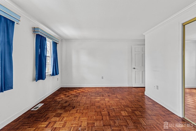 spare room featuring ornamental molding, visible vents, and baseboards
