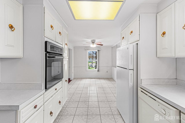 kitchen with light countertops, a ceiling fan, white cabinets, and white appliances