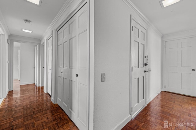 corridor featuring crown molding and baseboards