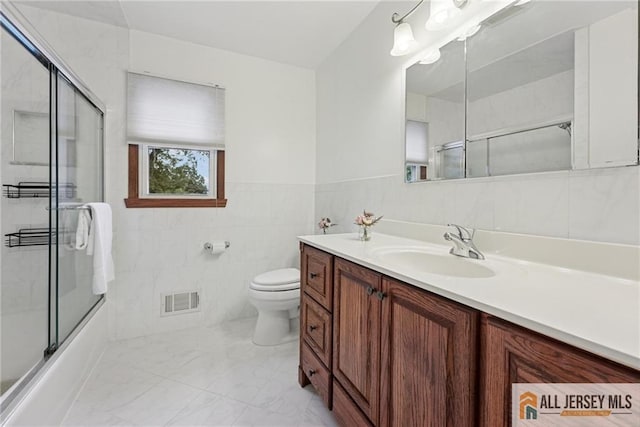 39 Evergreen Ter, Monroe, NJ 08831 - bathroom featuring vanity, tile walls, combined bath / shower with glass door, and marble finish flooring