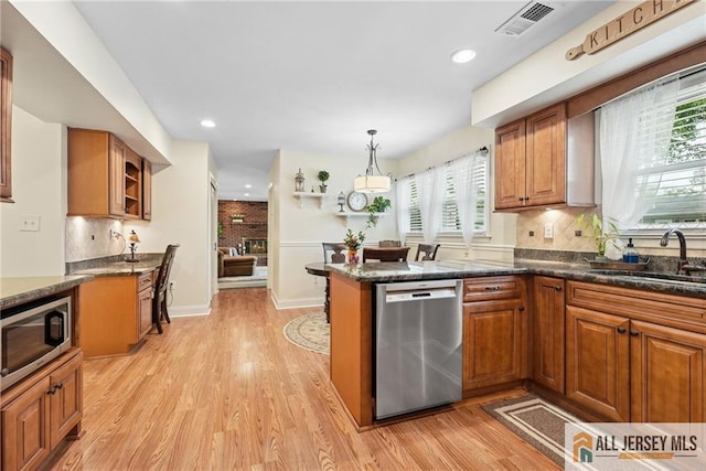 39 Evergreen Ter, Monroe, NJ 08831 - kitchen featuring stainless steel appliances, brown cabinetry, light wood-style flooring, and recessed lighting