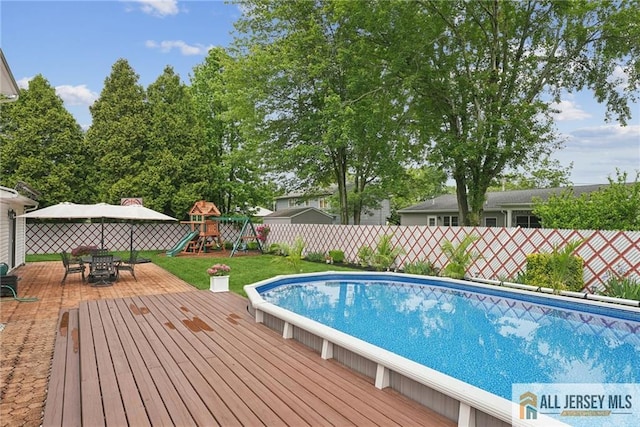 39 Evergreen Ter, Monroe, NJ 08831 - view of pool with a fenced backyard, a playground, and a wooden deck