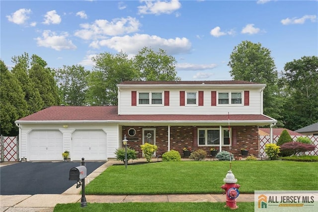 39 Evergreen Ter, Monroe, NJ 08831 - traditional-style home with an attached garage, asphalt driveway, a front lawn, and a porch