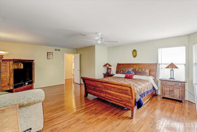 bedroom with ceiling fan and hardwood / wood-style flooring