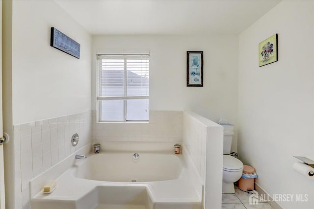 bathroom featuring a bath and toilet